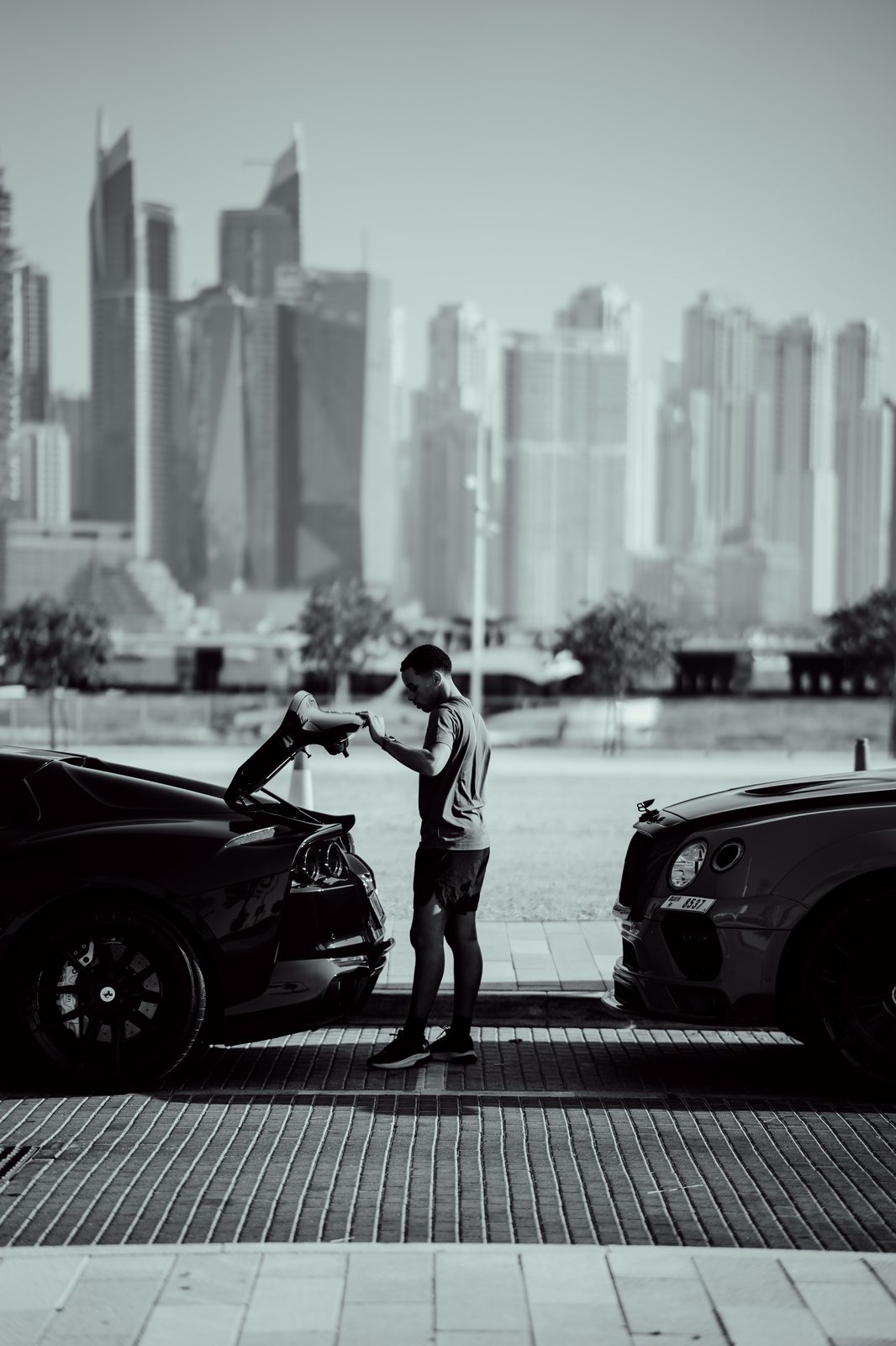 Ferrari 812 and Bentley Continental GT against the Dubai Marina skyline