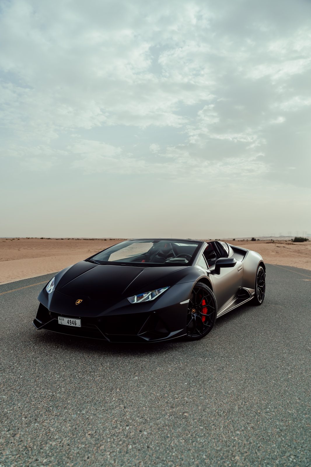 Matte black Lamborghini Huracán EVO Spyder parked on a desert road