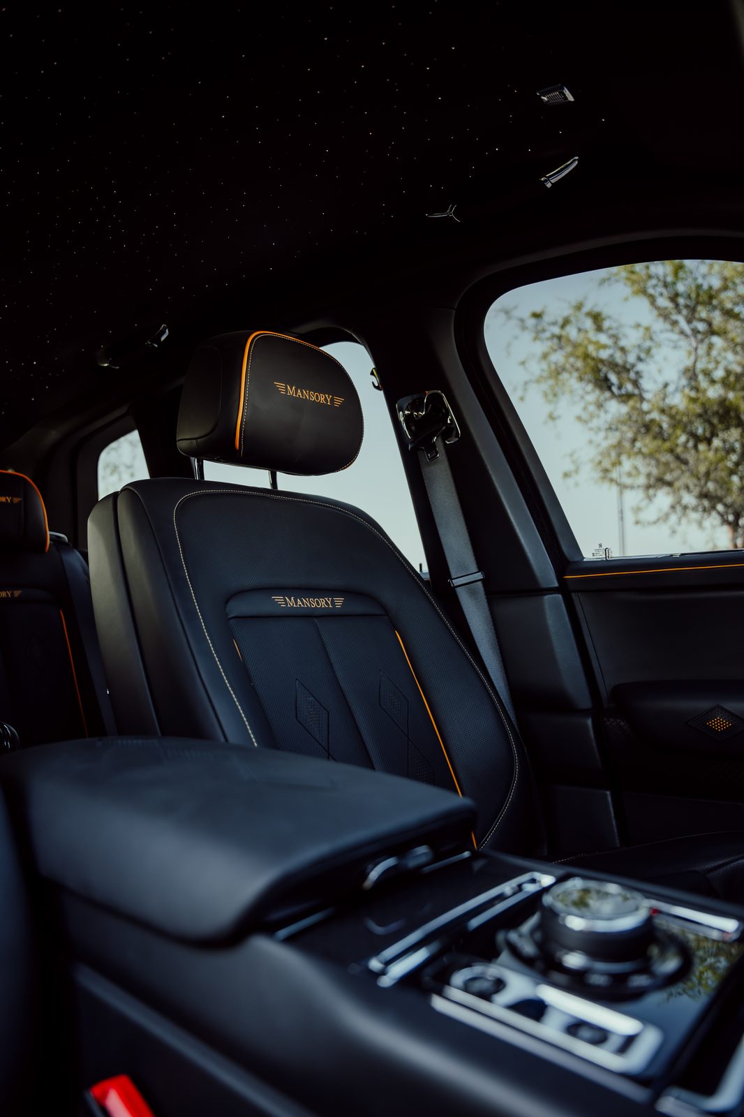Mansory Rolls-Royce Cullinan interior with starlight headliner and orange trim