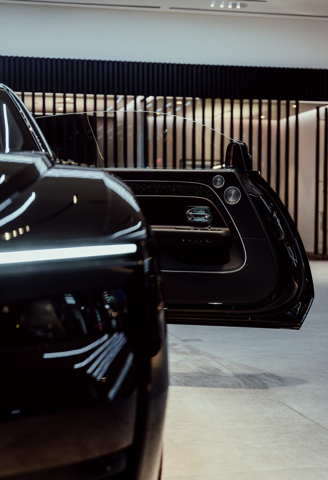 Rolls-Royce Spectre with its coach door open in the showroom